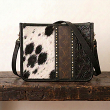 Load image into Gallery viewer, A crossbody bag with a black speckled hide and embossed black leather brown monogram canvas, swarvoski crystals and studs. Hide is unique and can vary slightly.
