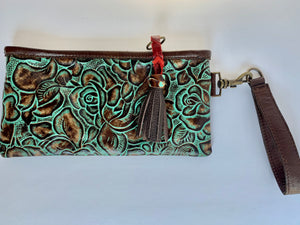 Wristlet made in embossed floral pattern leather